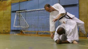 Practicing how to fall safely during an aikido class